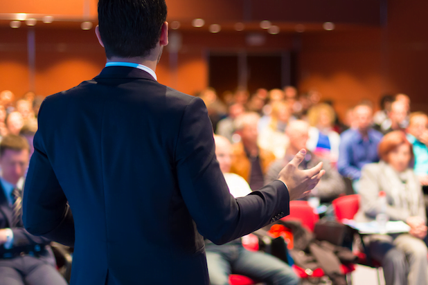 A man giving a presentation at a convention