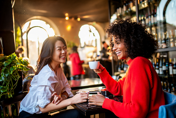 Two women chatting at a coffee shop