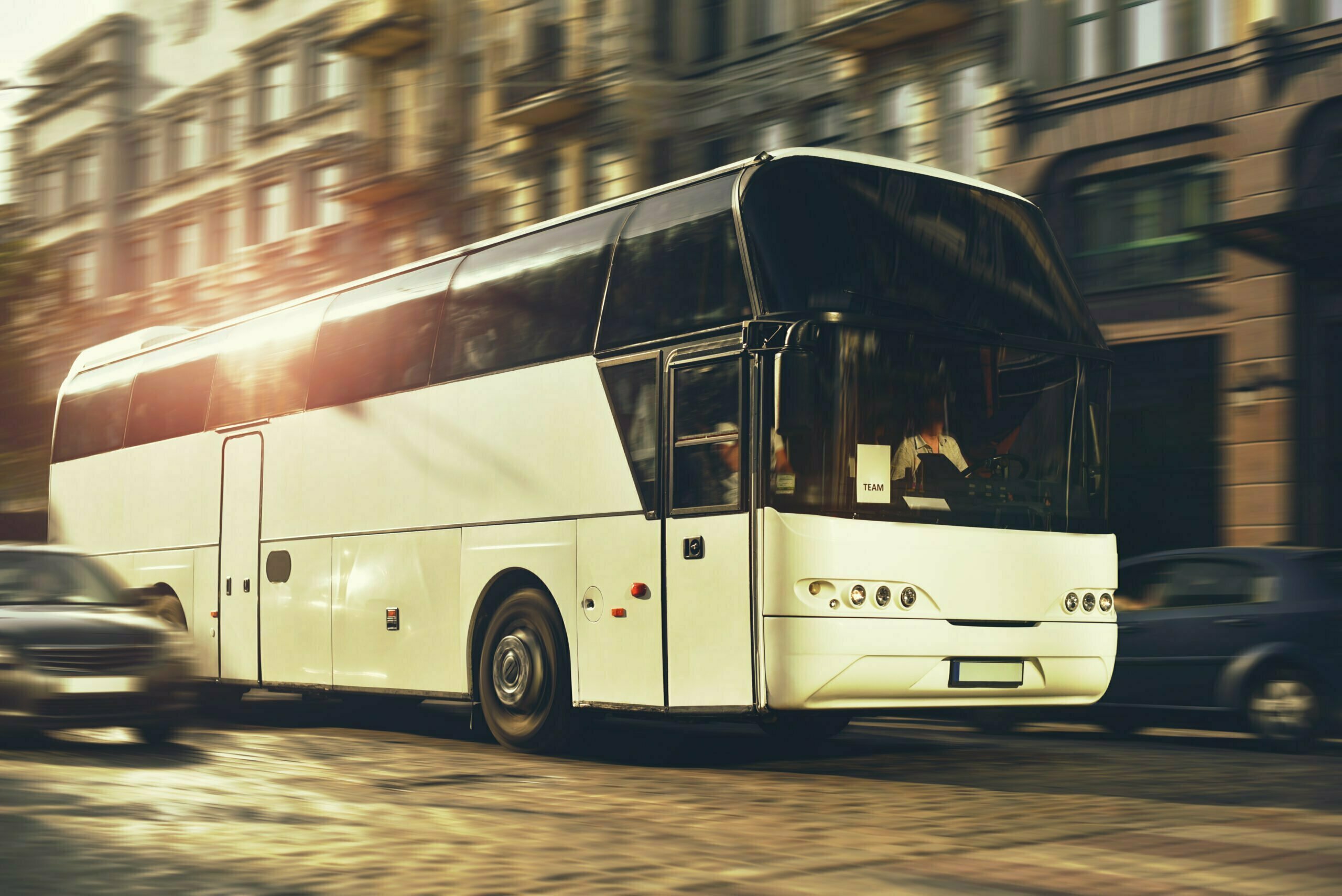 A white bus transporting travellers