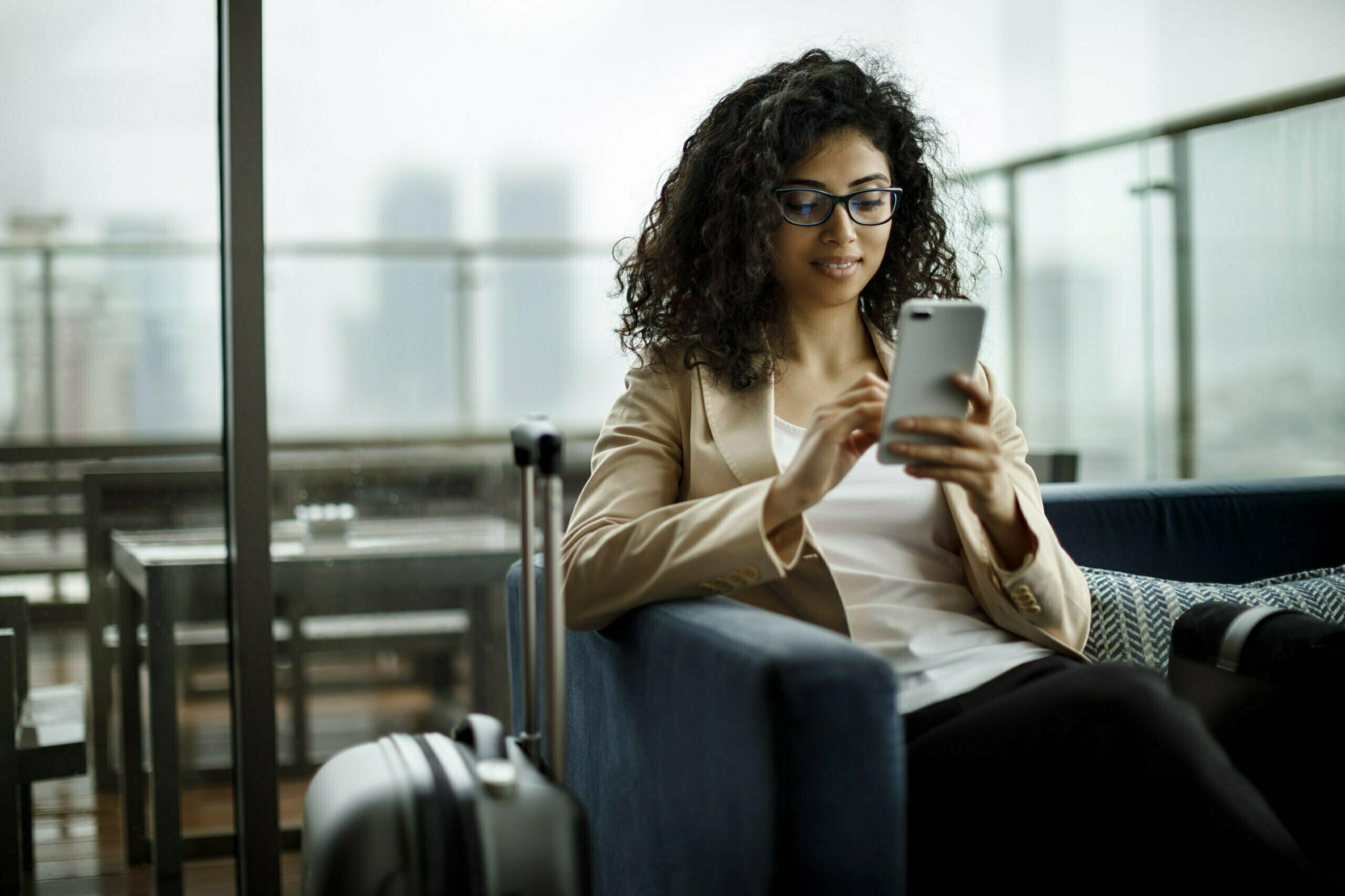 Corporate traveller reviewing trip details on phone