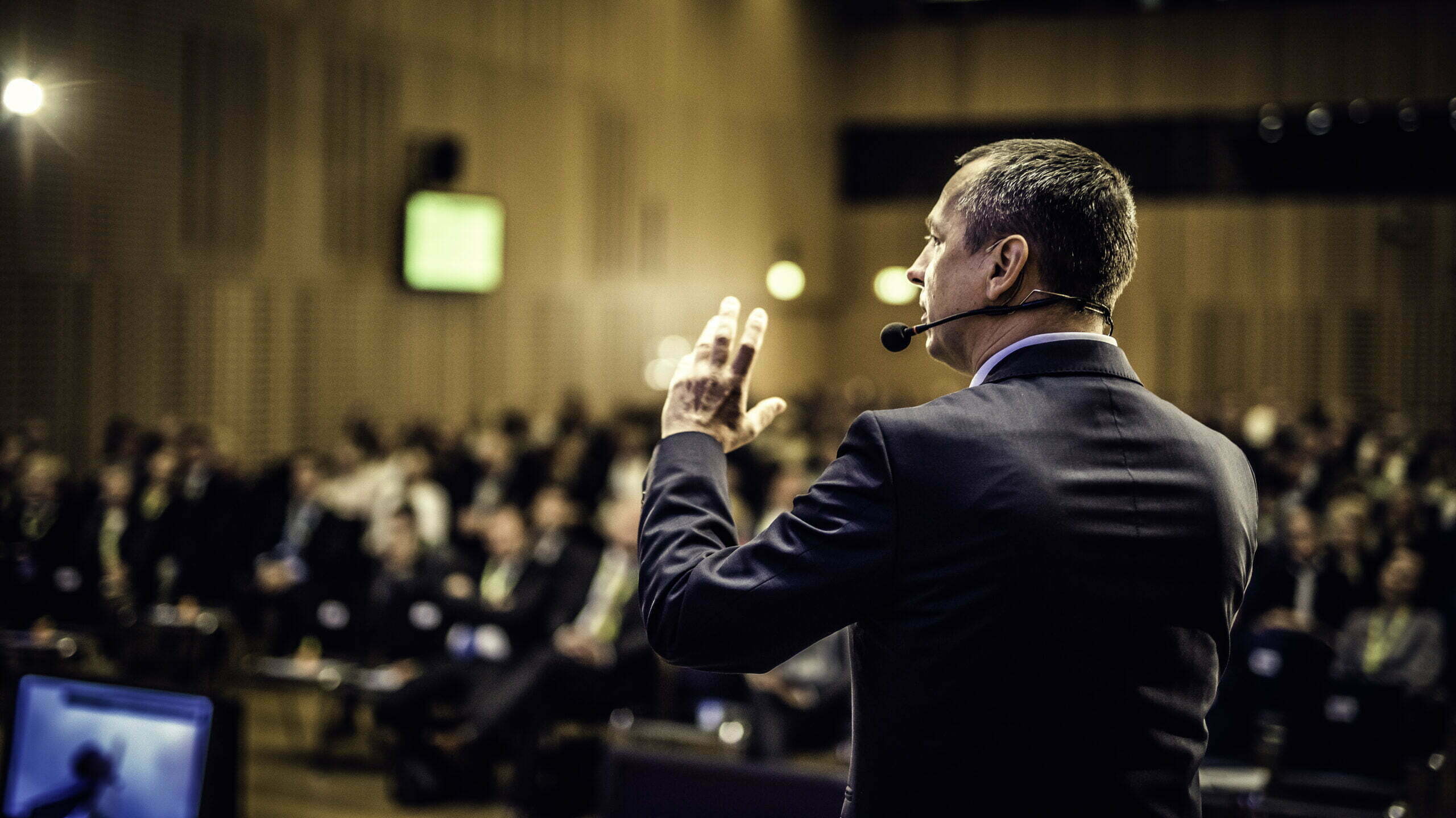 A speaker presenting at a conference